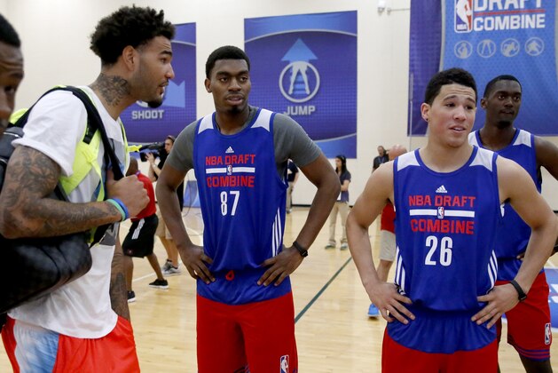 Kentucky's Willie Cauley-Stein, left, and teammates Dakari Johnson (87) and Devin Booker talk at the NBA basketball combine Friday, May 15, 2015, in Chicago. (AP Photo/Charles Rex Arbogast)