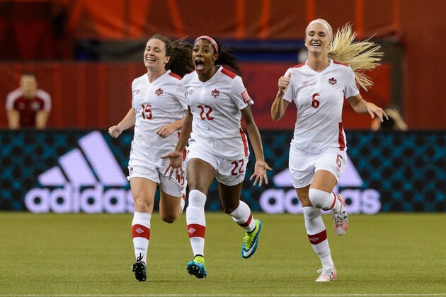 MONTREAL, QC - JUNE 15:  Ashley Lawrence #22 of Canada celebrates her goal with teammates in the first half during the 2015 FIFA Women's World Cup Group A match against the Netherlands at Olympic Stadium on June 15, 2015 in Montreal, Quebec, Canada. (Photo by Minas Panagiotakis/Getty Images)