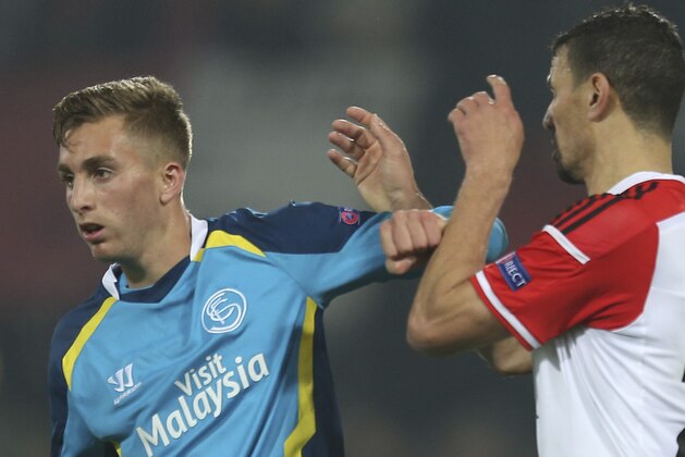 Sevilla's Gerard Deulofeu, left, uses his elbow to push Feyenoord's Khalid Boulahrouz, right, during the Group G Europa League match between Feyenoord and Sevilla at De Kuip Stadium in Rotterdam, Netherlands, Thursday, Nov. 27, 2014.  (AP Photo/Peter Dejong)