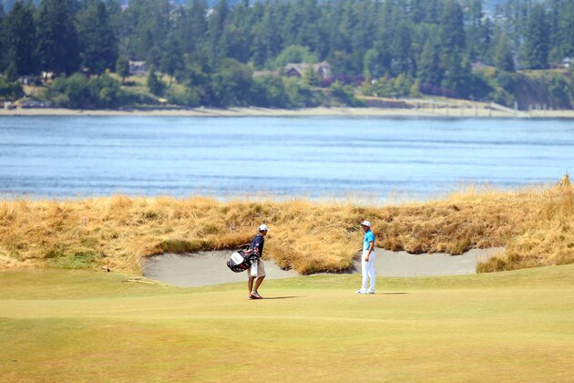 UNIVERSITY PLACE, WA - JUNE 15: Rickie Fowler of the United States speaks with his caddie Joe Skovron during a practice round prior to the start of the 115th U.S. Open Championship at Chambers Bay on June 15, 2015 in University Place, Washington.  (Photo by Andrew Redington/Getty Images)