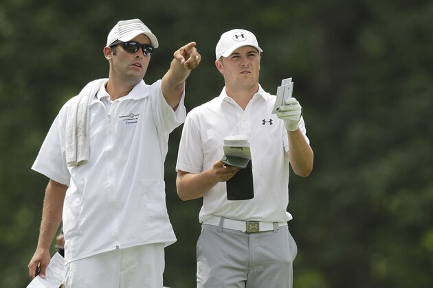 Jordan Spieth, right, and his caddie Michael Greller discuss a shot at the Memorial golf tournament Sunday, June 7, 2015, in Dublin, Ohio. (AP Photo/Jay LaPrete)