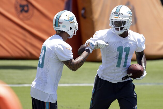 Miami Dolphins wide receiver DeVante Parker (11) bumps fists with Kenny Stills, left,  during an NFL football organized team activity, Monday, June 1, 2015, in Davie, Fla. (AP Photo/Lynne Sladky)