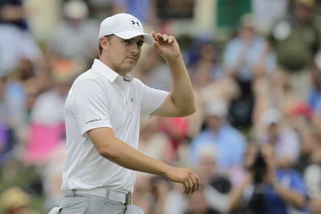 Jordan Spieth tips his hat to the crowd after making birdie on the 18th hole during the final round of the Memorial golf tournament Sunday, June 7, 2015, in Dublin, Ohio. (AP Photo/Jay LaPrete)