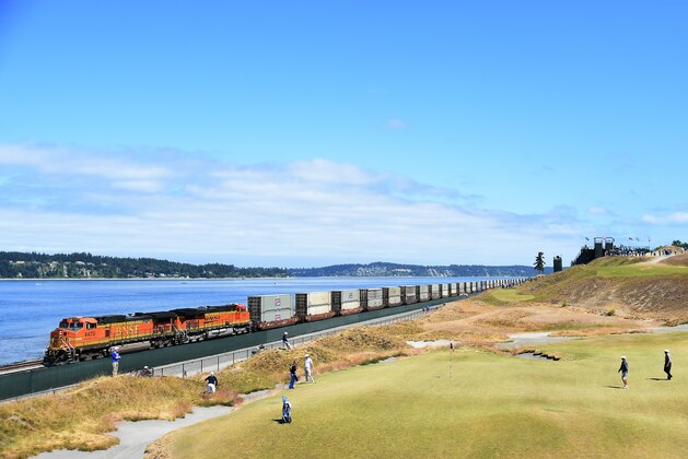 UNIVERSITY PLACE, WA - JUNE 16:  A train rambles past the 17th green during a practice round prior to the start of the 115th U.S. Open Championship at Chambers Bay on June 16, 2015 in University Place, Washington.  (Photo by Harry How/Getty Images)