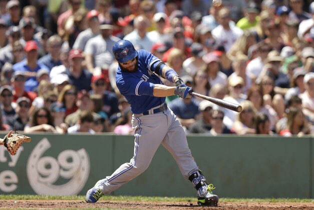 Toronto Blue Jays' Russell Martin hits an RBI-single off a pitch by Boston Red Sox's Eduardo Rodriguez in the fourth inning of a baseball game at Fenway Park, Sunday, June 14, 2015, in Boston. The Blue Jays won 13-5. (AP Photo/Steven Senne)