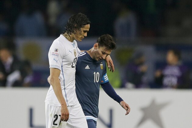 Uruguay's Edinson Cavani, left, leaves the pitch at half-time with Argentina's Lionel Messi , right, during a Copa America Group B soccer match at La Portada stadium in La Serena, Tuesday, June 16, 2015. (AP Photo/Ricardo Mazalan)