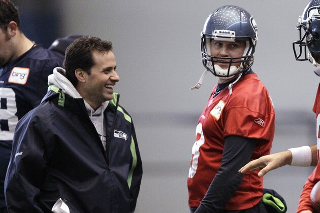 In this photo taken Tuesday, Jan. 4, 2011, Seattle Seahawks quarterback coach Jedd Fisch, left, talks with quarterback Matt Hasselbeck during an NFL football practice in Renton, Wash.Fisch has been hired as offensive coordinator and quarterbacks coach for the Miami Hurricanes on Thursday, Jan. 13, 2011.  He will remain with the Seahawks for the remainder of their playoff run. At Miami, he'll replace Mark Whipple, who wasn't retained by new coach Al Golden. (AP Photo/Elaine Thompson)