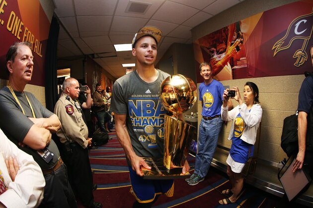 CLEVELAND, OH - JUNE 16:  Stephen Curry #30 of the Golden State Warriors celebrates with the Larry O'Brien NBA Championship Trophy after defeating the Cleveland Cavaliers in Game Six of the 2015 NBA Finals at Quicken Loans Arena on June 16, 2015 in Cleveland, Ohio. NOTE TO USER: User expressly acknowledges and agrees that, by downloading and or using this photograph, user is consenting to the terms and conditions of Getty Images License Agreement.  (Photo by Ezra Shaw/Getty Images)