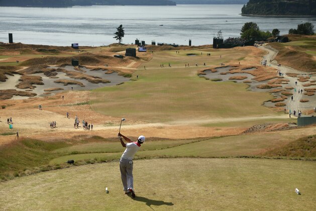 Alex Kim watches his tee shot on the fifth hole during a practice round for the U.S. Open golf tournament at Chambers Bay on Tuesday, June 16, 2015 in University Place, Wash. (AP Photo/Charlie Riedel)