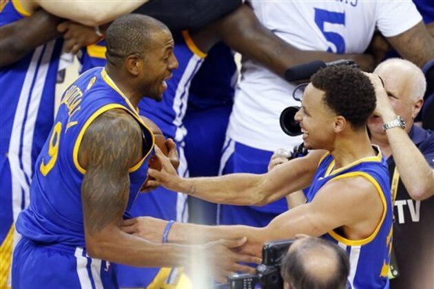 Golden State Warriors guard Stephen Curry (30), right, and guard Andre Iguodala (9) celebrate after winning Game 6 of basketball's NBA Finals in Cleveland, Tuesday, June 16, 2015. The Warriors defeated the Cavaliers 105-97 to win the best-of-seven game series 4-2. (AP Photo/Paul Sancya)