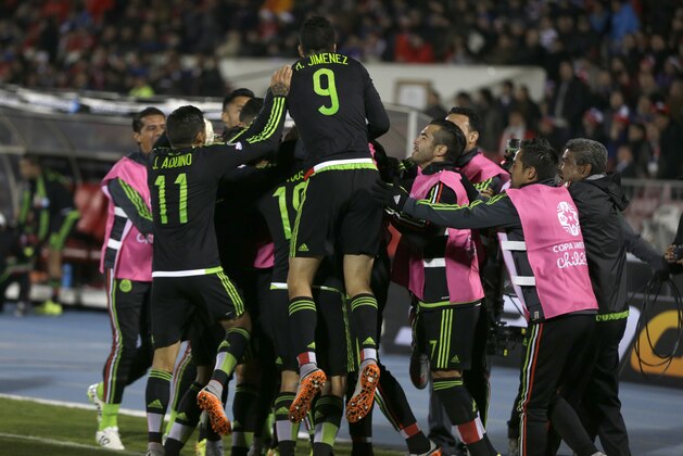 Mexico's players celebrate after scoring their third goal against Chile during a Copa America Group A soccer match at El Nacional stadium in Santiago, Chile, Monday, June 15, 2015. (AP Photo/Ricardo Mazalan)