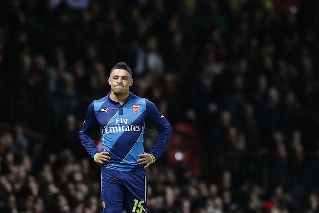Arsenal's Alex Oxlade-Chamberlain waits to rejoin play following an injury during the English FA Cup quarterfinal soccer match between Manchester United and Arsenal at Old Trafford Stadium, Manchester, England, Monday, March 9, 2015. (AP Photo/Jon Super)