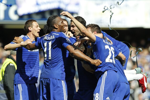Chelsea players celebrate after the English Premier League soccer match between Chelsea and Crystal Palace at Stamford Bridge stadium in London, Sunday, May 3, 2015.  Chelsea won the match 1-0 to secure Premier League title with 3 games to spare. (AP Photo/Alastair Grant)