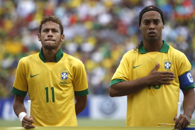 Brazil's Neymar, left, and Ronaldinho stand during the playing of their national anthem before a friendly soccer match with Bolivia in Santa Cruz, Bolivia, Saturday, April 6, 2013. Brazil won 4-0. (AP Photo/Juan Karita)