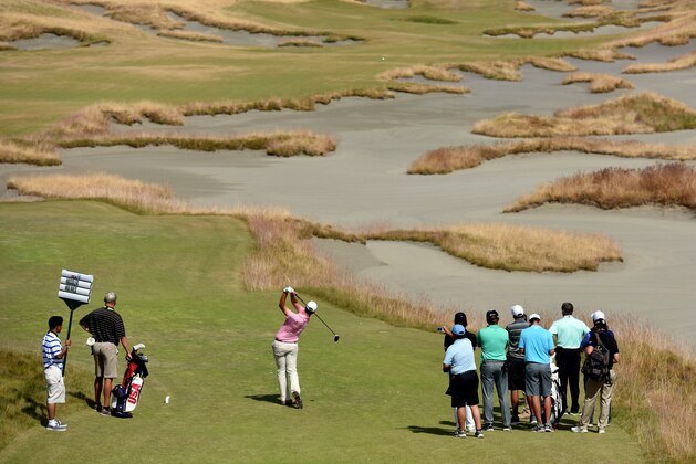 UNIVERSITY PLACE, WA - JUNE 16:  Beau Hossler of the United States hits a shot as J.B. Holmes looks on during a practice round prior to the start of the 115th U.S. Open Championship at Chambers Bay on June 16, 2015 in University Place, Washington.  (Photo by Ross Kinnaird/Getty Images)