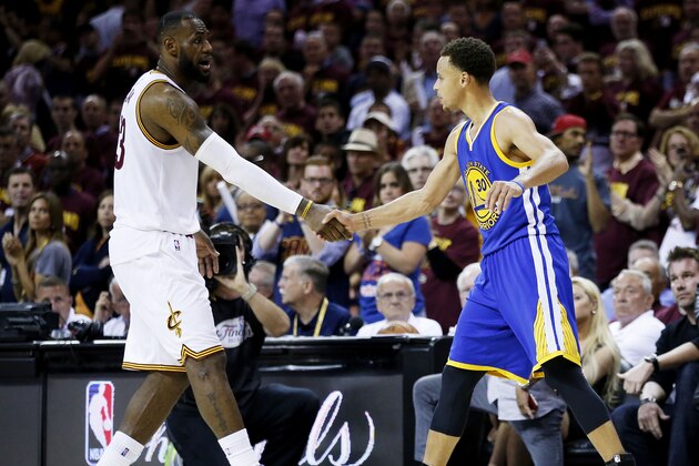 CLEVELAND, OH - JUNE 16:  LeBron James #23 of the Cleveland Cavaliers shakes hands with Stephen Curry #30 of the Golden State Warriors after the Warriors defeated the Cavs 105 to 97 to win Game Six of the 2015 NBA Finals at Quicken Loans Arena on June 16, 2015 in Cleveland, Ohio. NOTE TO USER: User expressly acknowledges and agrees that, by downloading and or using this photograph, user is consenting to the terms and conditions of Getty Images License Agreement.  (Photo by Ezra Shaw/Getty Images)