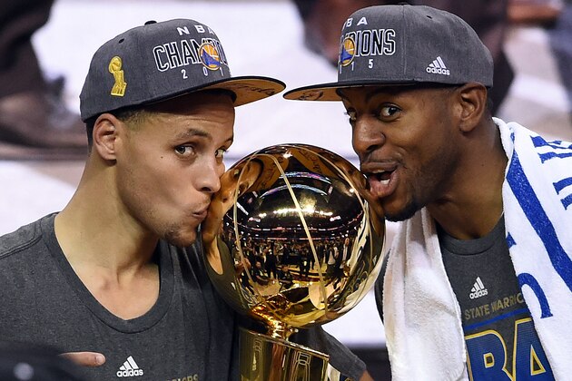 CLEVELAND, OH - JUNE 16:  Stephen Curry #30 and Andre Iguodala #9 of the Golden State Warriors celebrate with the Larry O'Brien NBA Championship Trophy after defeating the Cleveland Cavaliers in Game Six of the 2015 NBA Finals at Quicken Loans Arena on June 16, 2015 in Cleveland, Ohio. NOTE TO USER: User expressly acknowledges and agrees that, by downloading and or using this photograph, user is consenting to the terms and conditions of Getty Images License Agreement.  (Photo by Jason Miller/Getty Images)