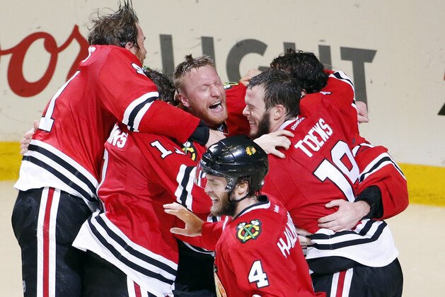 Members of the Chicago Blackhawks celebrate after defeating the Tampa Bay Lightning in Game 6 of the NHL hockey Stanley Cup Final series on Monday, June 15, 2015, in Chicago. The Blackhawks defeated the Lightning 2-0 to win the series 4-2. (AP Photo/Charles Rex Arbogast)