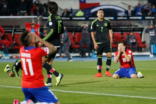 Chile's Jorge Valdivia, right, and Eduardo Vargas, left, react during a Copa America Group A soccer match against Mexico at El Nacional stadium in Santiago, Chile, Monday, June 15, 2015. The match ended in a 3-3 draw. (AP Photo/Silvia Izquierdo)