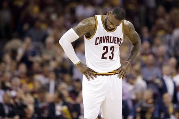 Cleveland Cavaliers forward LeBron James (23) hangs his head during the second half of Game 6 of basketball's NBA Finals against the Golden State Warriors in Cleveland, Tuesday, June 16, 2015. (AP Photo/Tony Dejak)