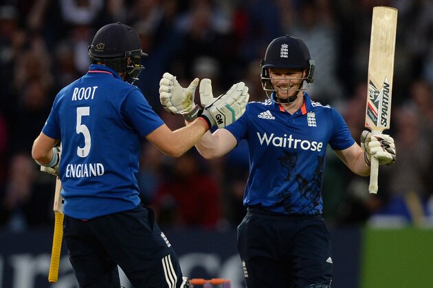 NOTTINGHAM, ENGLAND - JUNE 17:  England captain Eoin Morgan celebrates with Joe Root after reaching his century during the 4th ODI Royal London One-Day match between England and New Zealand at Trent Bridge on June 17, 2015 in Nottingham, England.  (Photo by Gareth Copley/Getty Images)