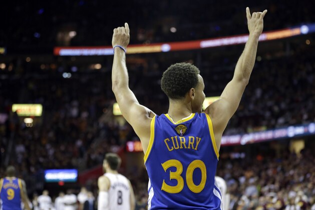 Golden State Warriors guard Stephen Curry (30) celebrates during the second half of Game 6 of basketball's NBA Finals against the Cleveland Cavaliers in Cleveland, Tuesday, June 16, 2015. The Warriors defeated the Cavaliers 105-97 to win the best-of-seven game series 4-2. (AP Photo/Tony Dejak)