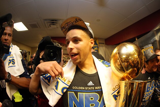CLEVELAND, OH - JUNE 16:  Stephen Curry #30 of the Golden State Warriors celebrates with the Larry O'Brien NBA Championship Trophy in the locker room after they defeated the Cleveland Cavaliers 105 to 97 in Game Six of the 2015 NBA Finals at Quicken Loans Arena on June 16, 2015 in Cleveland, Ohio. NOTE TO USER: User expressly acknowledges and agrees that, by downloading and or using this photograph, user is consenting to the terms and conditions of Getty Images License Agreement.  (Photo by Ezra Shaw/Getty Images)