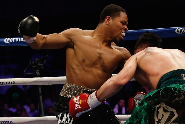 Apr 19, 2014; Washington, DC, USA; Shawn Porter (black gloves and Paulie Malignaggi (red gloves) in action during their bout at DC Armory. Mandatory Credit: Geoff Burke-USA TODAY Sports