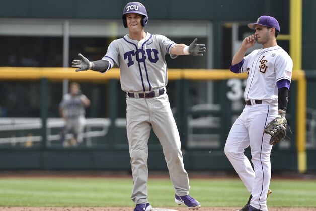 TCU's Derek Odell, left, celebrates his double as LSU first baseman Chris Chinea, right, looks on  in the sixth inning of an NCAA College World Series baseball game in Omaha, Neb., Sunday, June 14, 2015. (AP Photo/Mike Theiler)