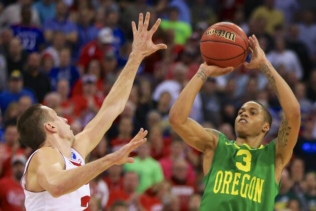 Oregon's Joseph Young (3) shoots over Wisconsin's Bronson Koenig during the first half of an NCAA tournament college basketball game in the Round of 32 in Omaha, Neb., Sunday, March 22, 2015. (AP Photo/Nati Harnik)