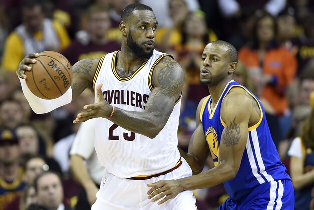Jun 16, 2015; Cleveland, OH, USA; Cleveland Cavaliers forward LeBron James (23) handles the ball against Golden State Warriors guard Andre Iguodala (9) during the fourth quarter in game six of the NBA Finals at Quicken Loans Arena. Mandatory Credit: Bob Donnan-USA TODAY Sports