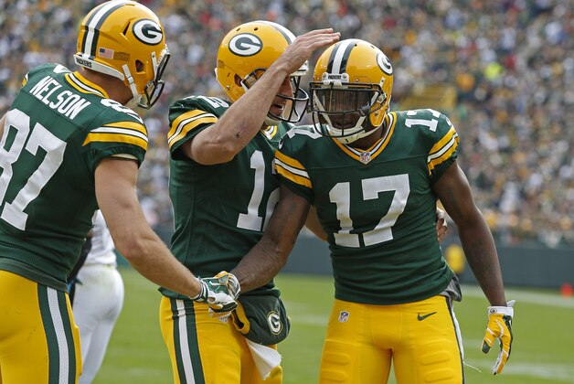 Green Bay Packers wide receiver Davante Adams (17) is congratulated by quarterback Aaron Rodgers (12) and wide receiver Jordy Nelson (87) after scoring a touchdown against the Carolina Panthers during an NFL football game Sunday Oct. 19, 2014, in Green Bay, Wis. (AP Photo/Matt Ludtke)