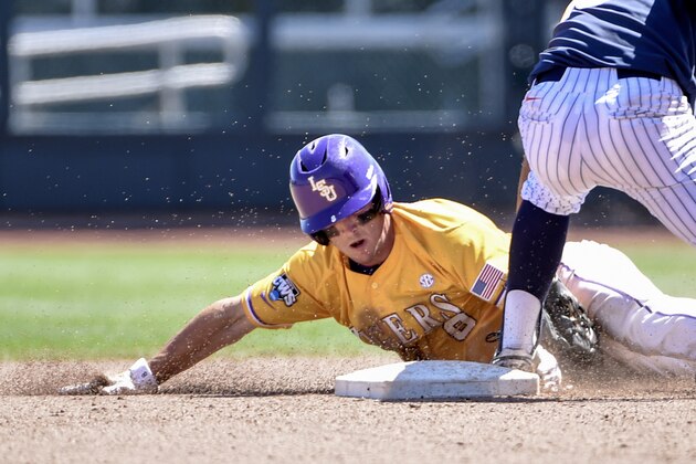 LSU's Alex Bregman (8) grabs the foot of Cal State Fullerton shortstop Timmy Richards as he steals second base in the fourth inning of an NCAA College World Series baseball elimination game at TD Ameritrade Park in Omaha, Neb., Tuesday, June 16, 2015. (AP Photo/Mike Theiler)