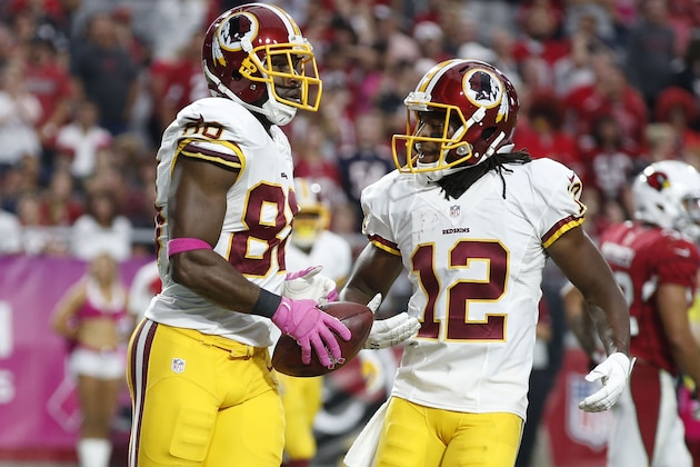 Washington Redskins wide receiver Pierre Garcon (88) celebrate with Andre Roberts (12) after scoring a touchdown against the Arizona Cardinals during the second half of an NFL football game, Sunday, Oct. 12, 2014, in Glendale, Ariz.(AP Photo/Ross D. Franklin)