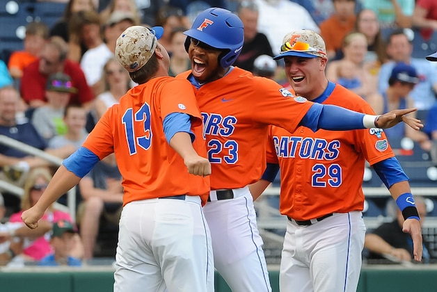 Jun 17, 2015; Omaha, NE, USA; Florida Gators outfielder Buddy Reed (23) celebrates with pitcher Kirby Snead (13) after hitting a home run during the first inning against the Miami Hurricanes in the 2015 College World Series at TD Ameritrade Park. Mandatory Credit: Steven Branscombe-USA TODAY Sports