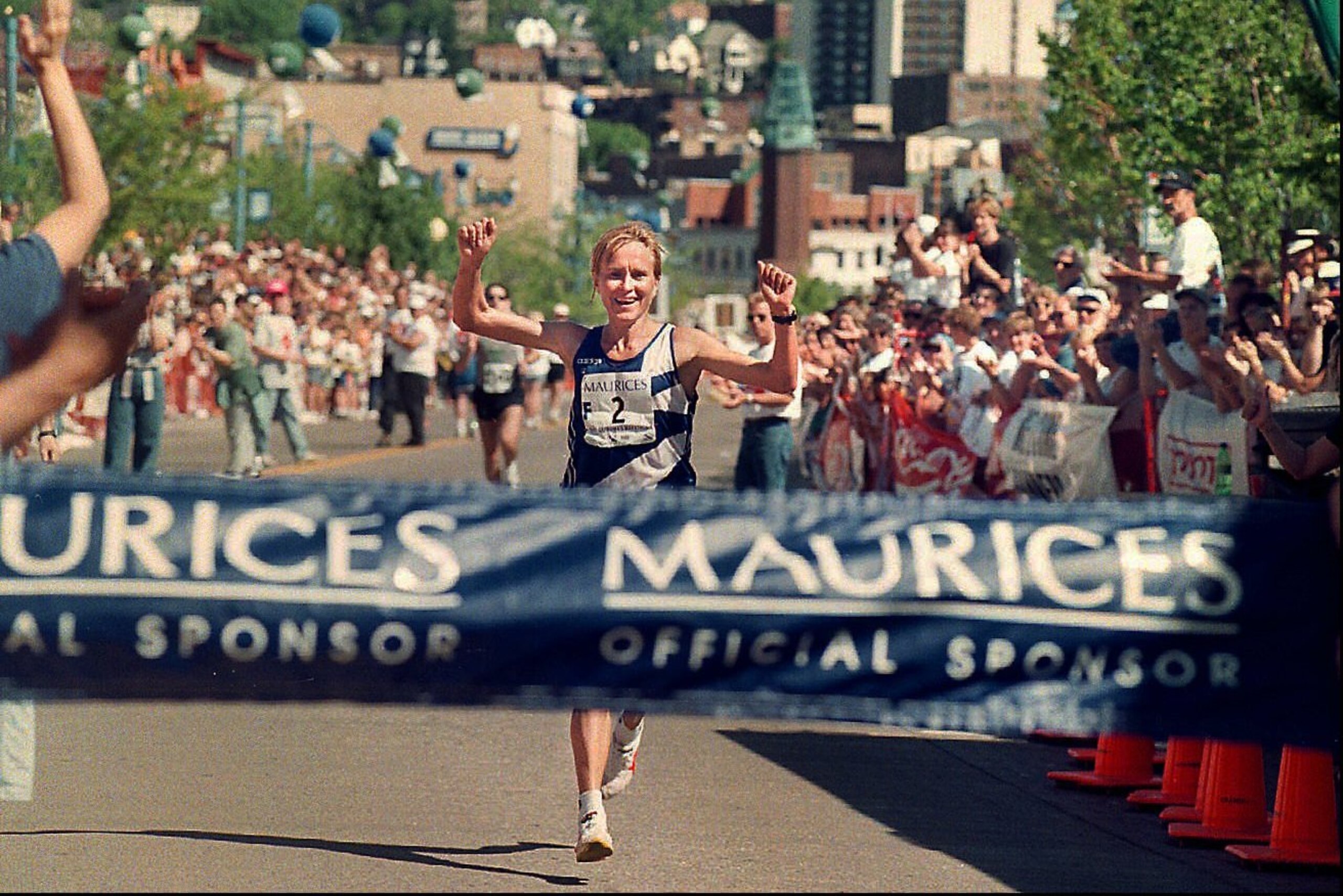 Irena Bogacheva, of Kirghizstan, raises her arms prior to crossing  the finish line to win the women's race for Grandma's Marathon on Saturday, June 21, 1997, in Duluth, Minn. Bogacheva finished unofficially at 2:38:45 and takes home a $7,000 first prize. (AP Photo/Duluth News-Tribune, Kathy Strauss)