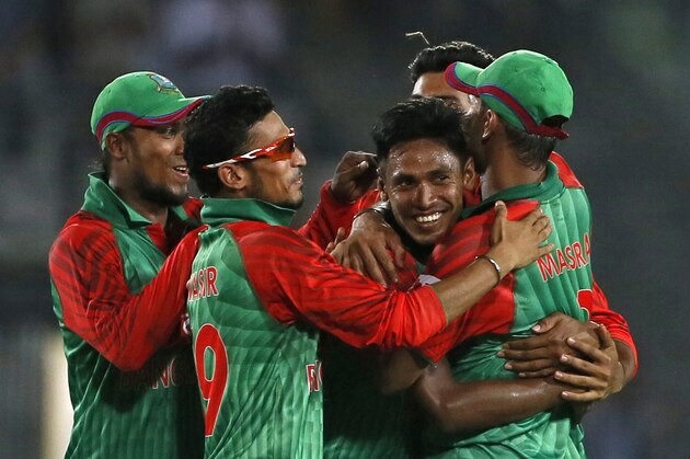 Bangladesh’s Mustafizur Rahman, center, celebrates with teammates the dismissal of India’s Suresh Raina during the first one-day international cricket match between them in Dhaka, Bangladesh, Thursday, June 18, 2015. (AP Photo/ A.M. Ahad)
