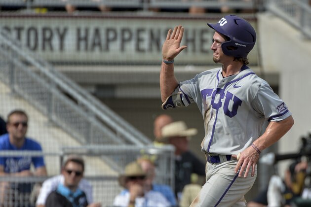 TCU's Cody Jones celebrates his run on a throwing error after stealing third base against LSU, in the seventh inning of an NCAA College World Series baseball game in Omaha, Neb., Sunday, June 14, 2015. (AP Photo/Ted Kirk)