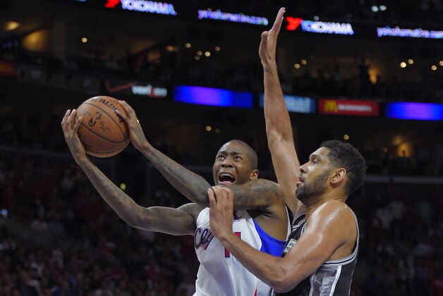 Los Angeles Clippers guard Jamal Crawford, left, shoots as San Antonio Spurs forward Tim Duncan defends during the second half of Game 5 of a first-round NBA basketball playoff series, Tuesday, April 28, 2015, in Los Angeles. The Spurs won 111-107. (AP Photo/Mark J. Terrill)
