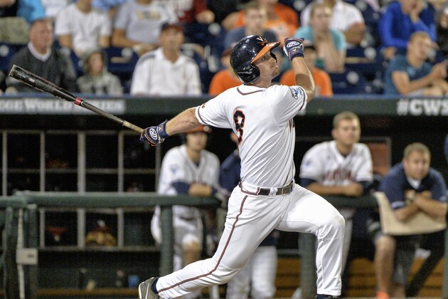 Virginia's Robbie Coman (8) hits a sacrifice fly that scored Matt Thaiss during the sixth inning of an NCAA College World Series baseball game against Florida in Omaha, Neb., Monday, June 15, 2015. (AP Photo/Ted Kirk)