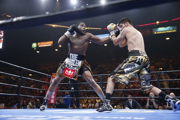 Adrien Broner, left, trades punches with John Molina Jr. during their boxing match, Saturday, March 7, 2015, in Las Vegas. Broner won by unanimous decision. (AP Photo/Eric Jamison)