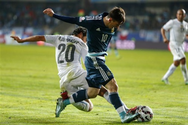 Argentina's Lionel Messi fights to escape Uruguay's Alvaro Gonzalez, left, during a Copa America Group B soccer match at La Portada stadium in La Serena, Chile, Tuesday, June 16, 2015. Argentina won the match 1-0. (AP Photo/Andre Penner)