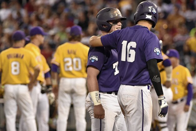 TCU's Evan Skoug and Connor Wanhanen (16), celebrate after they scored on a two-run single by Dane Steinhagen in the fifth inning of an NCAA College World Series baseball elimination game against LSU in Omaha, Neb., Thursday, June 18, 2015. (AP Photo/Mike Theiler)