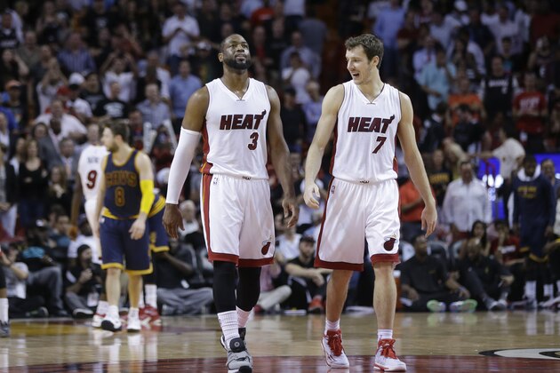Miami Heat's Dwyane Wade (3) and Goran Dragic (7) walk on the court during the second half of an NBA basketball game against the Cleveland Cavaliers, Monday, March 16, 2015, in Miami. The Heat defeated the Cavaliers 106-92. (AP Photo/Lynne Sladky)