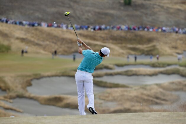 Rory McIlroy, of Northern Ireland, watches his tee shot on the fourth hole during the first round of the U.S. Open golf tournament at Chambers Bay on Thursday, June 18, 2015 in University Place, Wash. (AP Photo/Matt York)