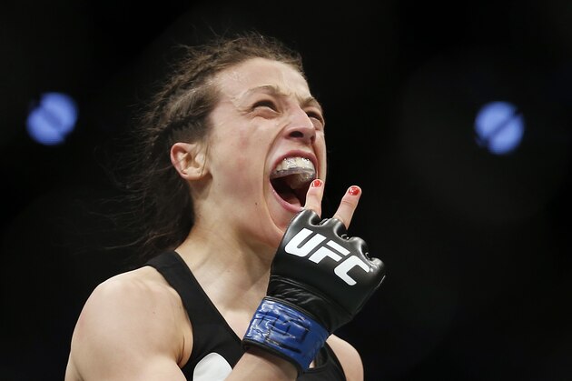 Joanna Jedrzejczyk, of Poland, celebrates defeating Carla Esparza in a women's strawweight UFC 185 mixed martial arts title bout, Saturday, March 14, 2015, in Dallas. Jedrzejczyk won by TKO in two rounds. (AP Photo/Brandon Wade)