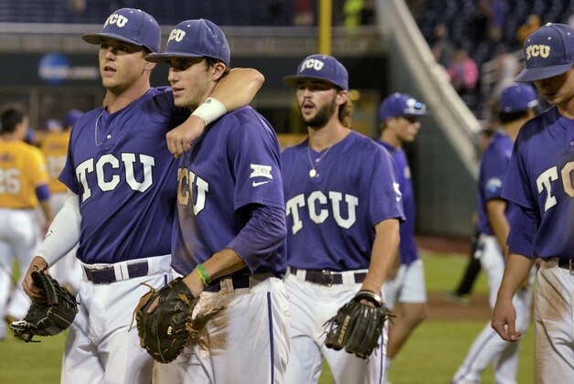 TCU third baseman Derek Odell, left, and first baseman Jeremie Fagnan, second from left, celebrate following an NCAA College World Series baseball elimination game in Omaha, Neb., Thursday, June 18, 2015. TCU defeated LSU 8-4. (AP Photo/Mike Theiler)