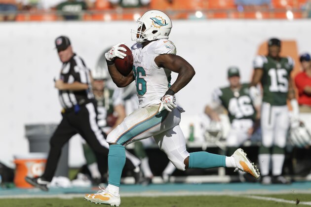 Miami Dolphins running back Lamar Miller (26) runs a 97 yard touchdown during the second half of an NFL football game against the New York Jets, Sunday, Dec. 28, 2014, in Miami Gardens, Fla. (AP Photo/Wilfredo Lee)