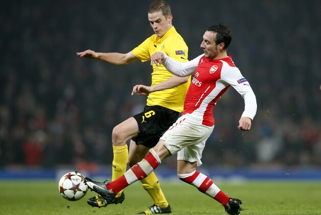 Dortmund's Sven Bender, left, battles for the ball with Arsenal's Santi Cazorla during the Champions League group D soccer match between Arsenal and Borussia Dortmund at the Emirates stadium in London, Wednesday, Nov. 26, 2014. (AP Photo/Alastair Grant)