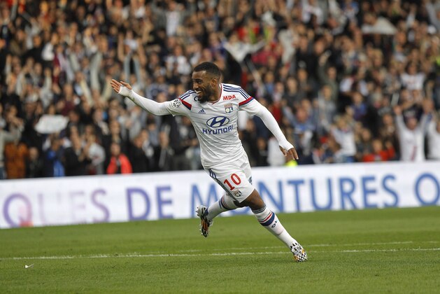 Lyon's Alexandre Lacazette celebrates after he scored his third goal against Lille,  during their French League One soccer match in Lyon, central France, Sunday, Oct. 5, 2014. (AP Photo/Laurent Cipriani)